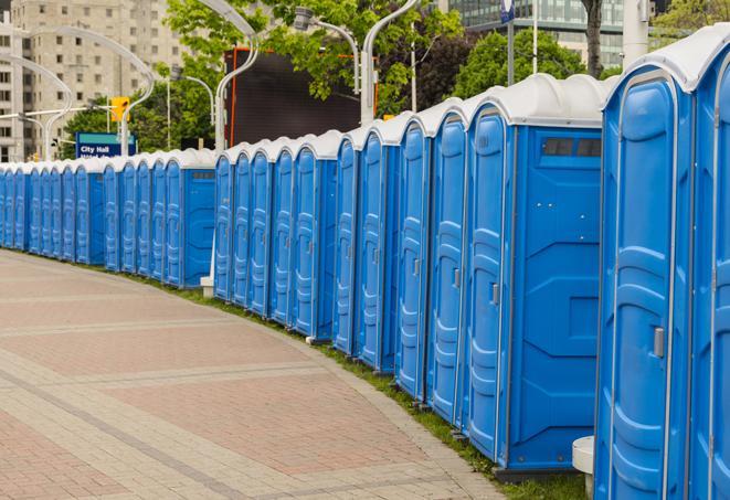 a line of portable restrooms at an outdoor wedding, catering to guests with style and comfort in Lathrop, MO